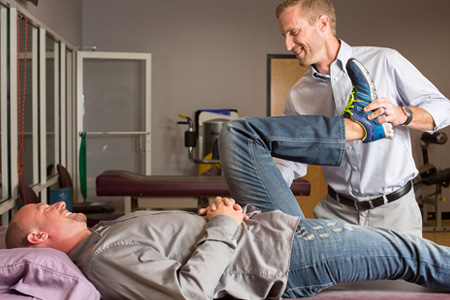 physical therapist working with patient