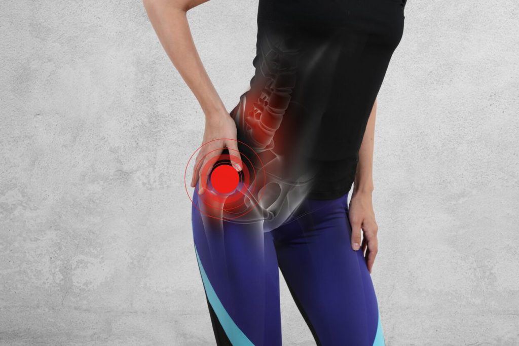 Woman experiencing hip pain after working out