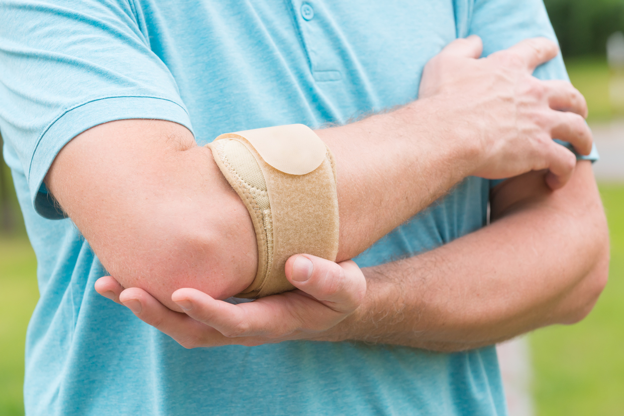 Man wearing elbow brace to reduce pain from cubital tunnel syndrome