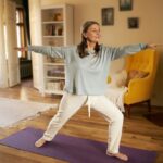 Woman moving on with her life after cervical disc replacement and practicing light yoga.