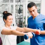 A physical therapist teaching sports medicine to an athlete