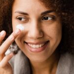 woman putting lotion on scar