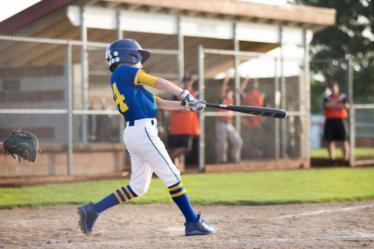 Youth baseball player batting, a demographic prone to growth plate fractures