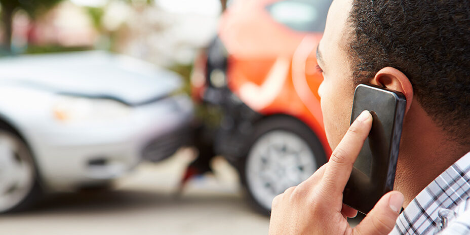 young man calling the doctor after a car accident