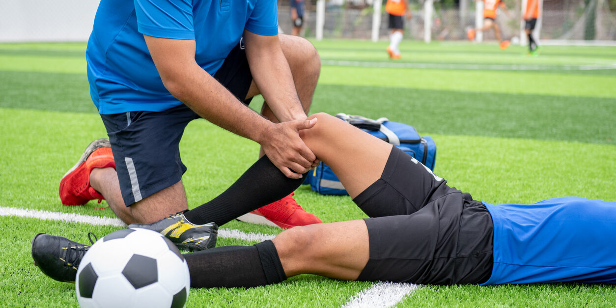 Soccer player in pain with a PCL injury